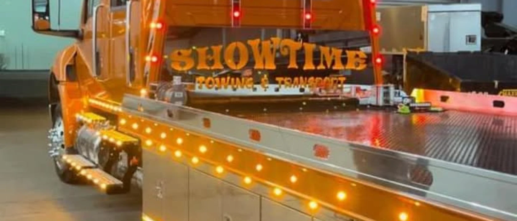 The Showtime Towing flatbed lit up in the shop